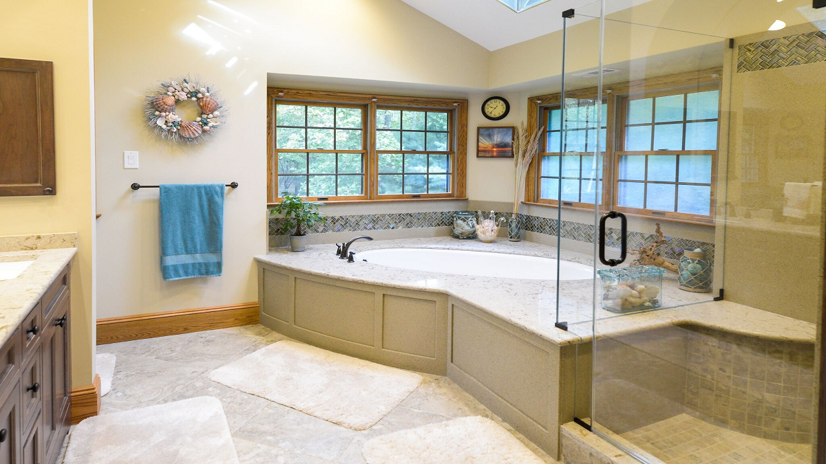 A beautifully renovated bathroom featuring modern fixtures, elegant tile work, and a spacious layout, showcasing the transformation achieved through complete bathroom renovations.